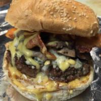 Evios Burger · Sauteed mushrooms, crispy bacon, blue cheese crumbles, and honey mustard sauce.