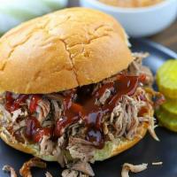 Pulled Pork Sandwich · Shredded pork drizzled with BBQ sauce.