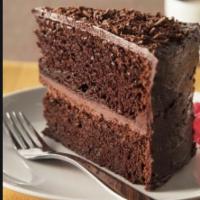 Chocolate Cake · Chocolate cake slice, light whipped chocolate frosting topped with chocolate shaving.