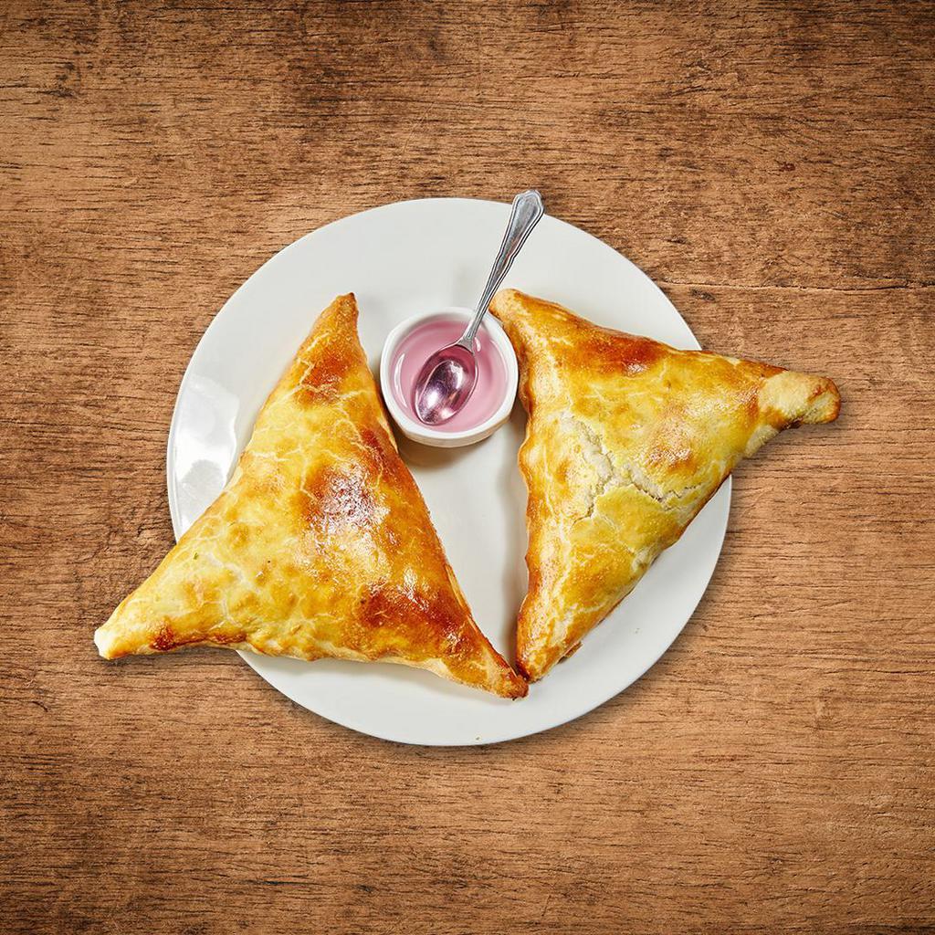 Samosa Factory · Crispy turnover stuffed with tender vegetables seasoned with Indian spices with a side of mint and tamarind relish.
