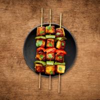 Charred Cottage Cheese Tikka · Tender pieces of Cottage cheese marinated with delicate spices and roasted in tandoor.
