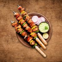Charred Chicken Tikka · Boneless chunks of chicken marinated in herbs and spices barbecued in a clay oven on a skewe...