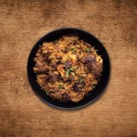 Yum Goat Biryani · Long grain premium basmati rice cooked with tender morsels of bone in goat meat in our signa...