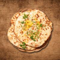 Butter Naan · House made hand pulled and leavened dough baked to perfection in an Indian clay oven and bas...