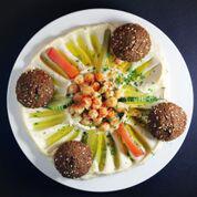7. Wally’s Falafel and Hummus Plate  · Tradition on a plate. 4 pieces of falafel on top of our homemade hummus served with 2 pitas.