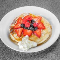 Lemon Ricotta Pancakes with Honey and Berries · Topped with mix berries and honey.
