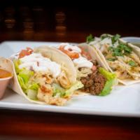 The Tasty Taco · A tortilla filled with lettuce, tomatoes, onions, shredded cheese and sour cream.