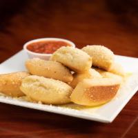 Garlic Breadsticks · Pizza dough transformed into breadsticks, topped with garlic cheese sauce. Served with marin...