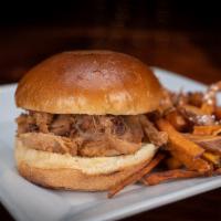 Pulled Pork Sandwich · Pulled pork covered in our homemade BBQ sauce on white bread. Served with your choice of side.