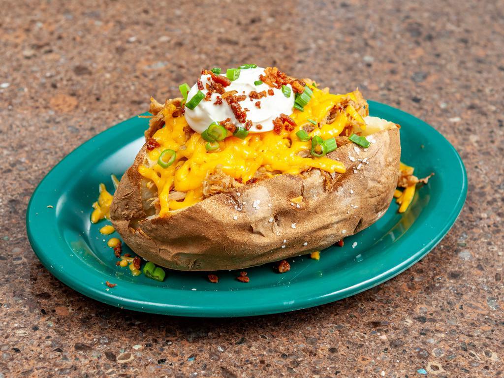 Spudsey Seigal with Meat · Master of BBQ size potato loaded with butter, sour cream, bacon bits, green onion and cheddar.