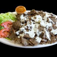 Lamb over Rice Platter · Seasoned halal meat, grilled onions served over yellow rice and fresh salad with our homemad...