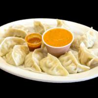 Chicken MoMo · Nepalese style chicken dumplings with coriander, ginger and garlic. Steamed and served with ...