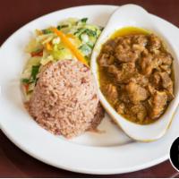 Curry Goat · Tender goat meat seasoned with our authentic blended curry powder. Served with rice and peas...