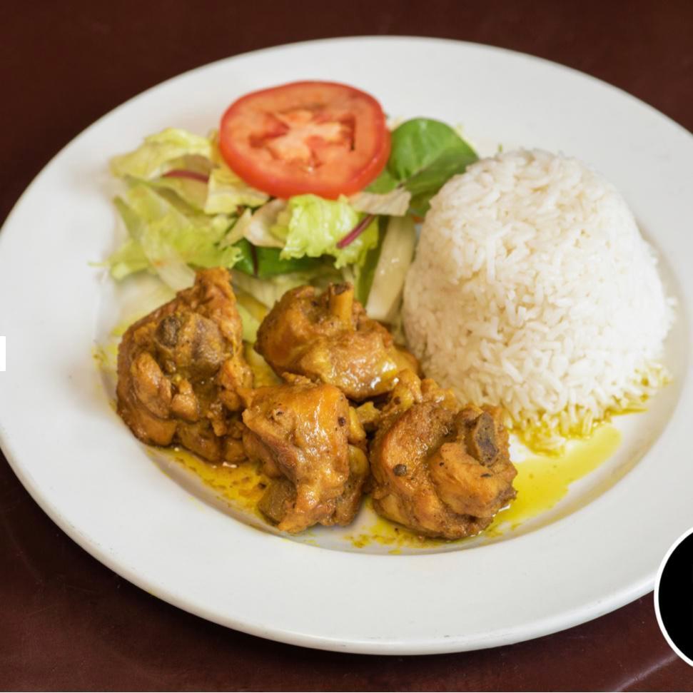 Curry Chicken · Seasoned with our authentic blended curry powder. Served with rice and peas or white rice, salad or steam cabbage.
