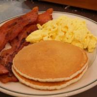 Buttermilk Short Stack Combo · Two short stack pancakes with two eggs any style and choice of breakfast meat. Served with b...