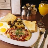Grilled Homemade Polenta & Eggs · Topped with Marinara & Cheese. Served with 2 Eggs any style, Breakfast Potatoes and Toast