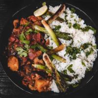 Chicken Tikka Masala Plate · Grilled chicken served in a spiced curry cream sauce, with cilantro lime rice and green onio...