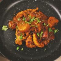 Chicken Tikka Masala · Chicken marinated in Indian spices and yogurt, served in our creamy curry sauce, garnished w...