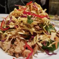 Calamari Napa Style · Hand-battered rings and tentacles in a sweet chili sauce topped with slaw and Thai peanut sa...