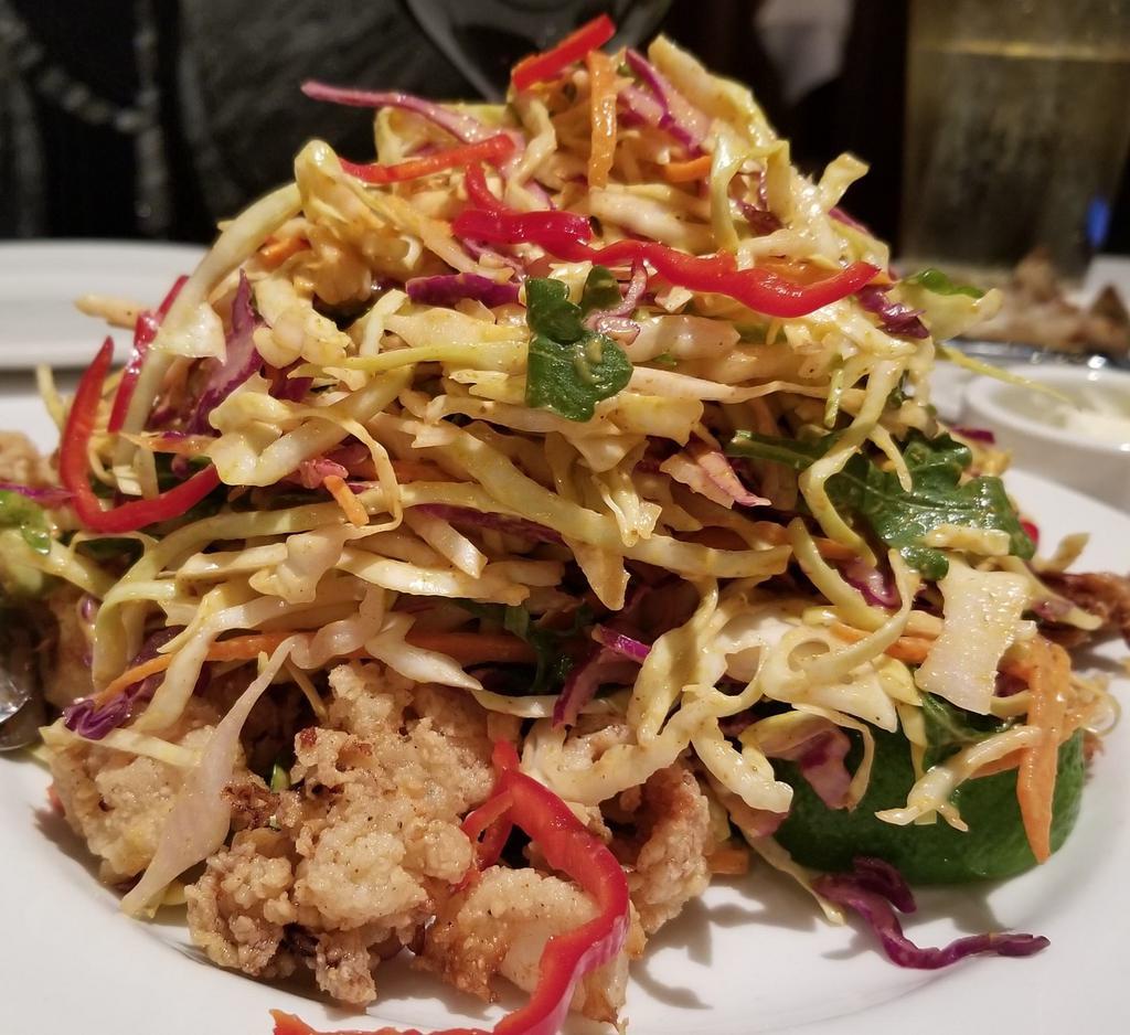 Calamari Napa Style · Hand-battered rings and tentacles in a sweet chili sauce topped with slaw and Thai peanut sauce.