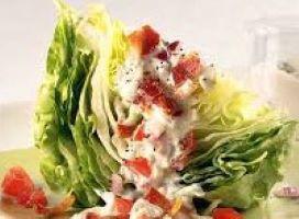Wedge Salad · Fresh tomato, blue cheese crumbles, bacon, and blue cheese dressing.