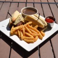 French Dip · House-shaved prime rib, Swiss cheese, and au jus.