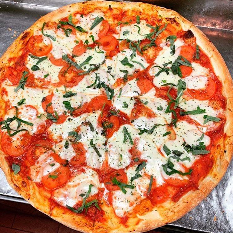 Margherita Pizza · Fresh Mozzarella, fresh basil, sliced Roma tomatoes and our homemade pizza sauce. Take our advice, ask for it crispy!