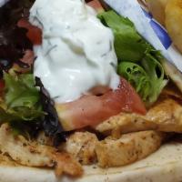 Chicken Gyro · Greek style seasoned chicken breast grilled and  wrapped in a pita with lettuce, tomato, and...