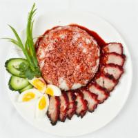 Khao Moo Dang · Slices of red roast pork served on rice covered with sticky soya sauce and boiled egg.