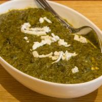 56. Paneer Saag · Fresh cottage cheese cooked with spinach and mustard leaves in Indian spices.