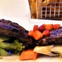 Churrasco · Grilled herb marinated Canadian skirt steak. Pick a side.