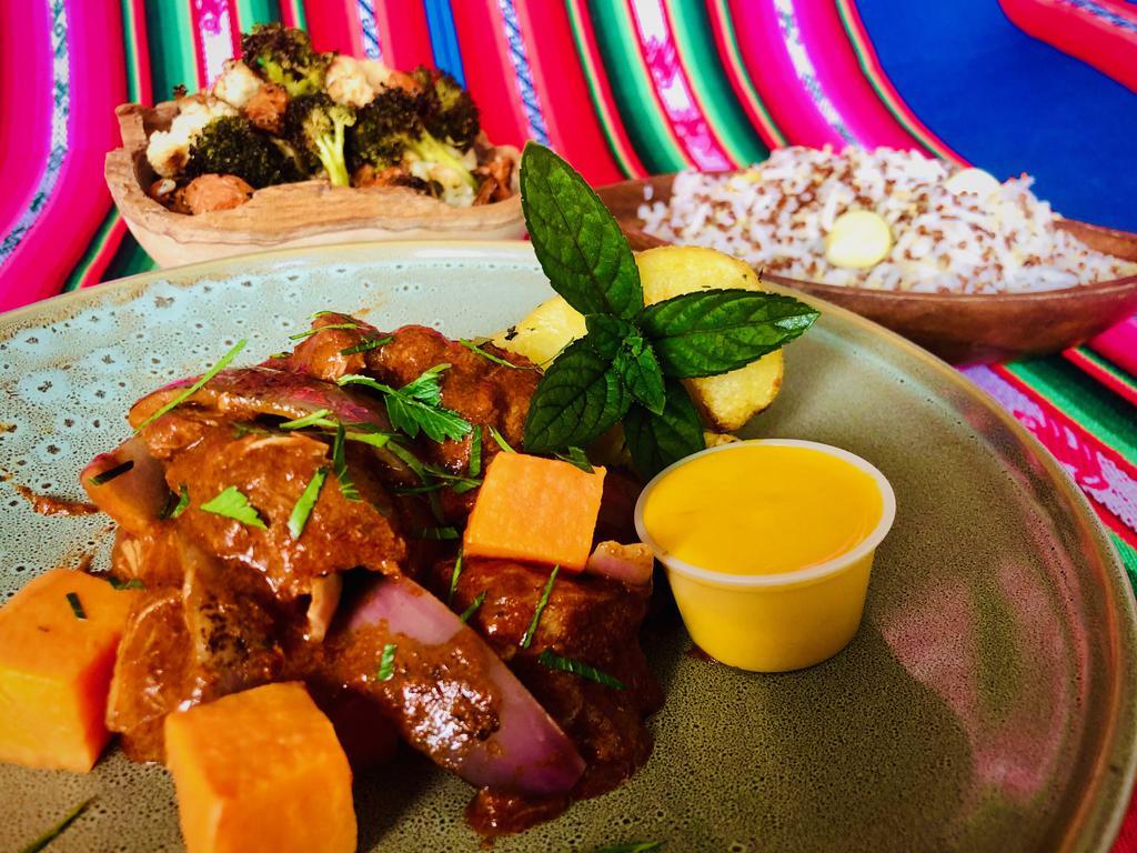Adobo · All-natural pork shoulder, braised in red chilies and corn beer, yams, yucca. It comes with Andean rice (rice with quinoa and heirloom Andean corn) and herb-roasted veggies and creamy Wonka sauce. Gluten-free, nut-free, shellfish-free, egg-free and soy-free.
