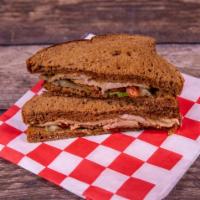 Turkey and Cheese Sandwich · Smoked turkey breast with cheese, lettuce and tomato.