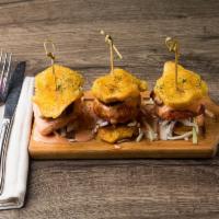 Chimi Tostones Sliders · Twice fried mini plantain burgers with white fried cheese, cabbage, tomatoes, house pink sau...