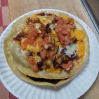 SP2. Mexican Pizza · 2 fried flat tortilla shells topped and layered with beans, chicken, ground beef with kidney...