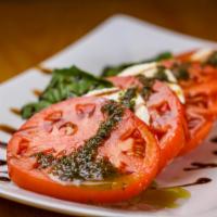 Caprese Salad · Fresh tomatoes, mozzarella, basil sauce, pine kernel with virgin oil olives and parmesan che...