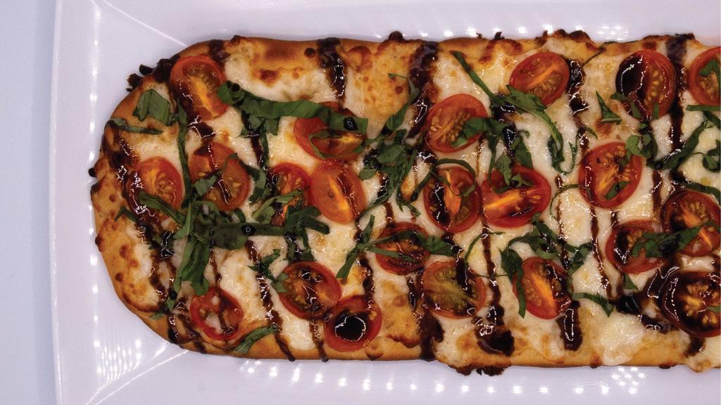 Margherita Flatbread · Olive Oil, Mozzarella Cheese Blend, and Grape Tomato, Topped with Fresh Basil and Balsamic Reduction 