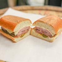 The Cuban Sandwich · Soft white roll, homemade pork shoulder, Black Forest ham, Swiss cheese, mayo, mustard, pick...