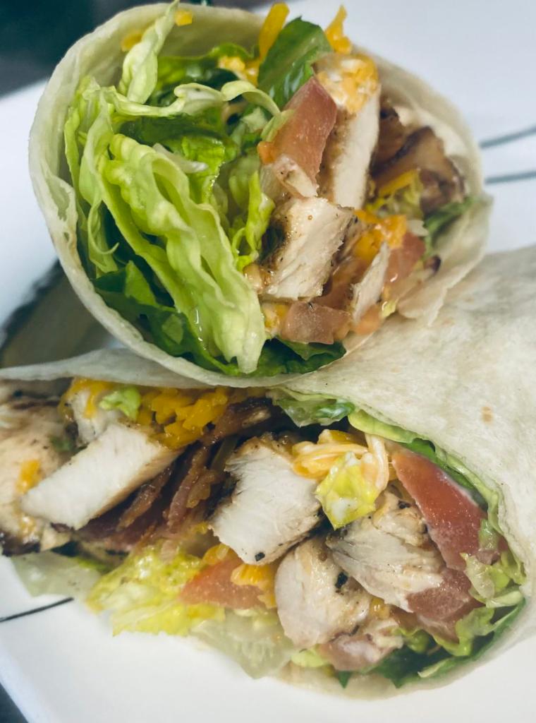 Chicken Bacon Ranch Wrap · Grilled chicken, bacon, cheddar cheese, lettuce, tomato, and ranch dressing wrapped in a tortilla.