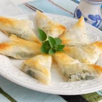 Spanakopita · Chopped spinach, diced onions and feta cheese. Served in a flaky puffed shell with house dre...