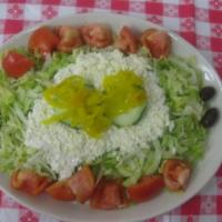 Greek Salad · Lettuce greens with tomatoes, cucumbers, banana peppers, Kalamata olives, feta cheese, and o...