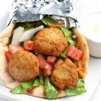 Falafel Sandwich · Falafel patties rolled into pita bread with a spread of hummus, topped with tomatoes, lettuc...