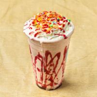 Fruity Pebble Milkshake · Strawberry milkshake blended with fruity pebbles, topped with whipped cream, crumbled strawb...