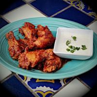Juan's Wings · Charred Jerk, Buffalo or spicy coconut sauce. Served with blue cheese dressing.