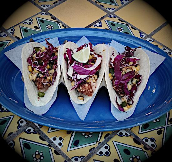 Original Fish Taco · Tortilla-encrusted fish, roasted corn salsa, shredded red cabbage, and chipotle aioli on soft tortillas.