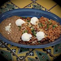 Enchiladas Rancheras · 2 cheese enchiladas baked in enchilada sauce topped with scallions and sour cream. Served wi...