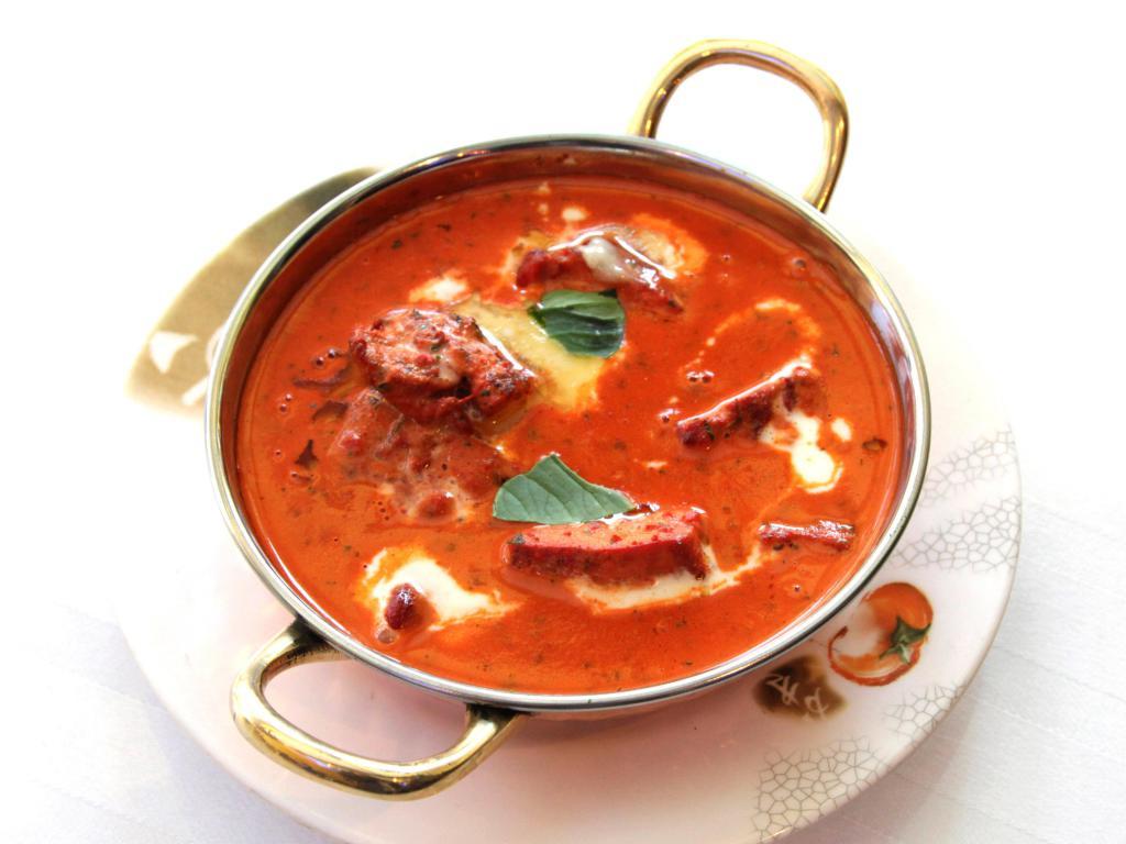 Chicken Tikka Masala · Boneless chicken marinated in yogurt, herbs and spices, grilled in tandoor and simmered in a tangy sauce of light cream and fresh tomatoes.