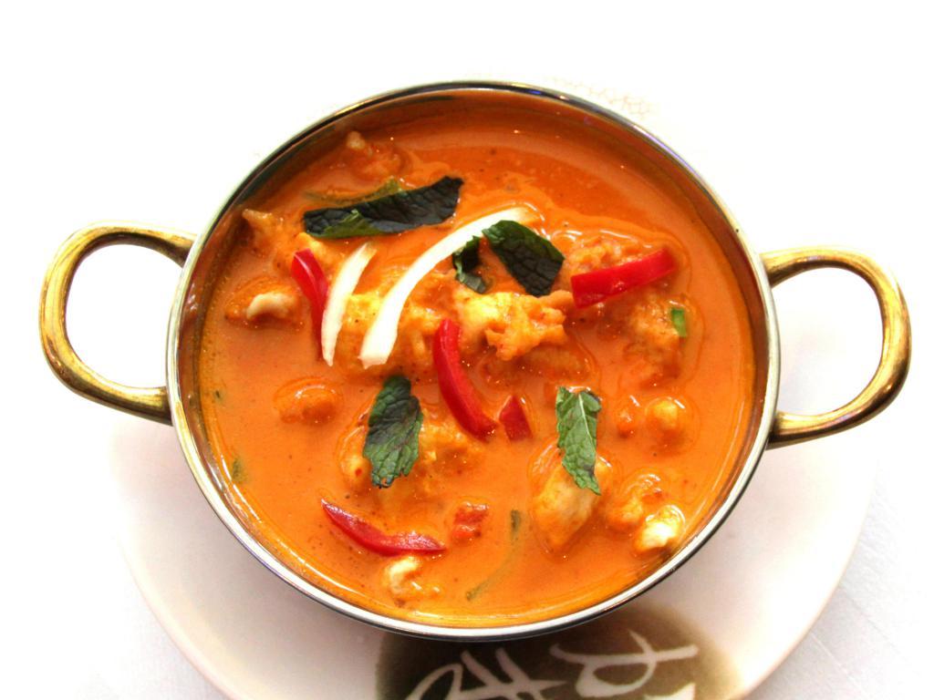 Butter Chicken · Boneless chicken marinated in yogurt, herbs and spices, grilled in tandoor and simmered in a tangy sauce of light cream, fresh tomatoes and butter.