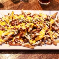 Loaded Tavern Fries · Hand-cut fries topped with bacon, jalapenos and cheese, drizzled with ranch dressing.