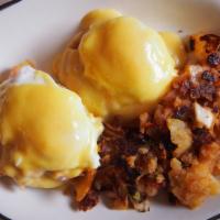 Eggs Benedict · Two poached eggs on an English muffin with Canadian bacon, topped with hollandaise sauce. Se...